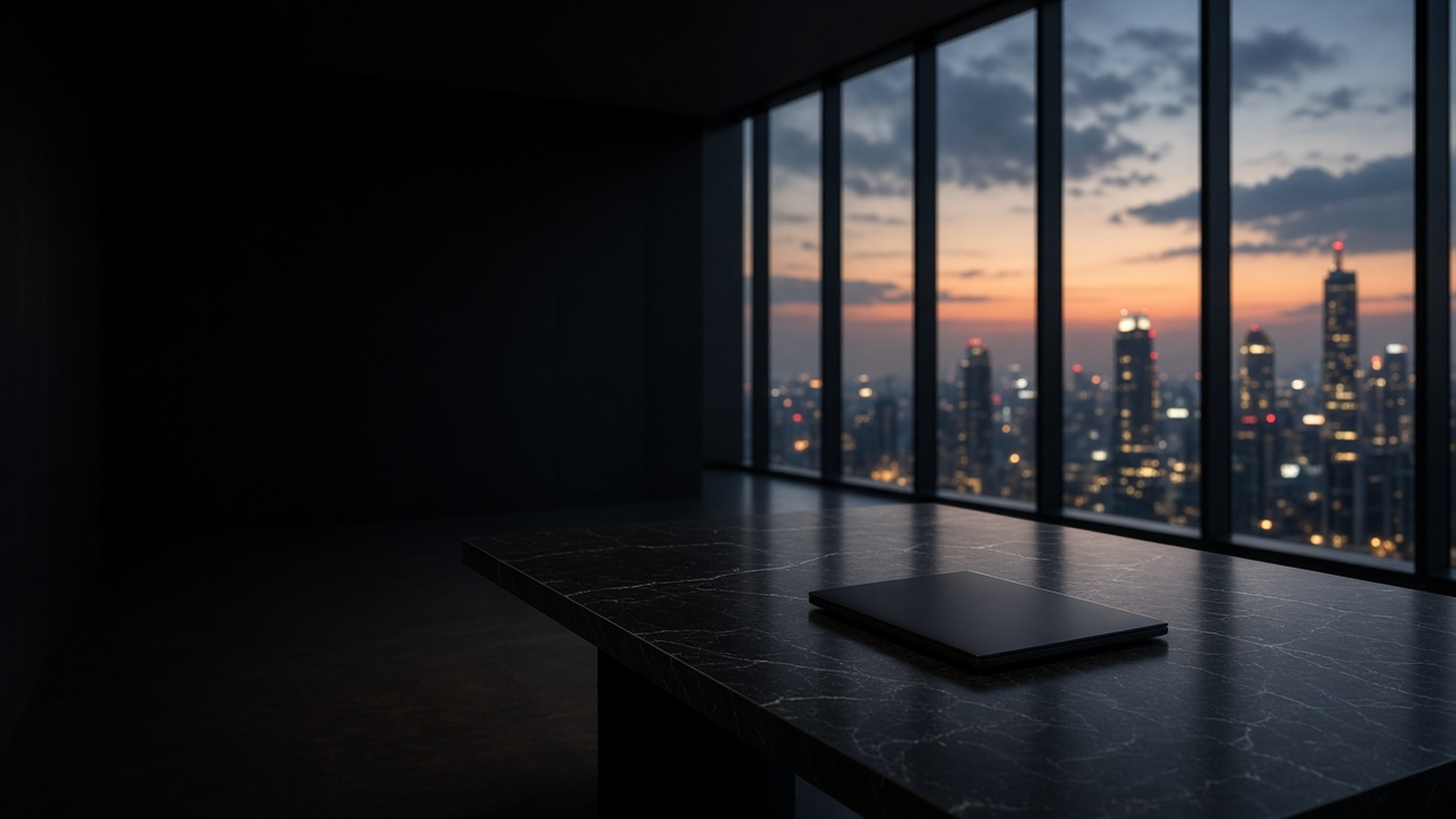 Empty night-time office overlooking a city skyline